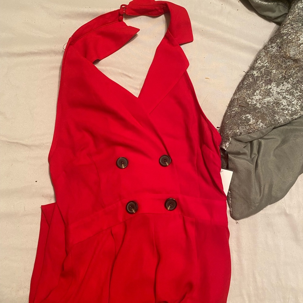 Red romper with legs that flare out. Size small.